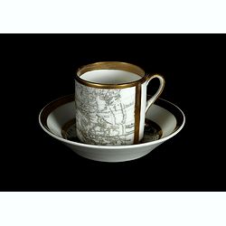 Coffee cup and plate with map design.